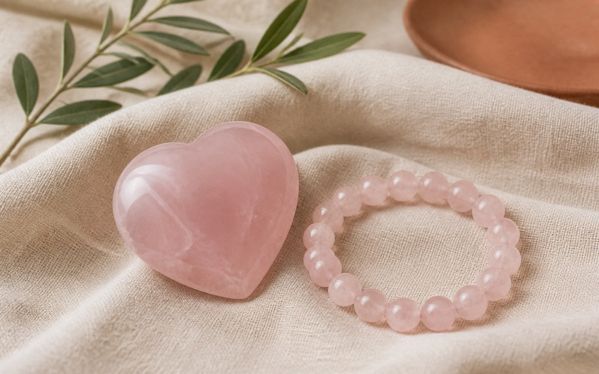 A polished rose quartz heart and bead bracelet on cream linen